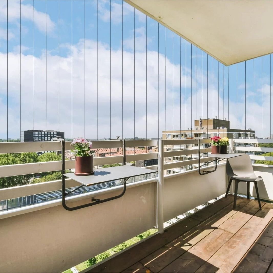 Modern apartment building with invisible stainless steel grills installed by JNS Safety Nets Hyderabad